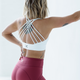 Woman wearing white high support crossback sports bra for gym training