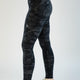 Person wearing black camouflage leggings on a white background